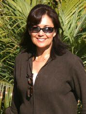 Suzanne Herrera-McCullough wearing sunglasses and a big smile